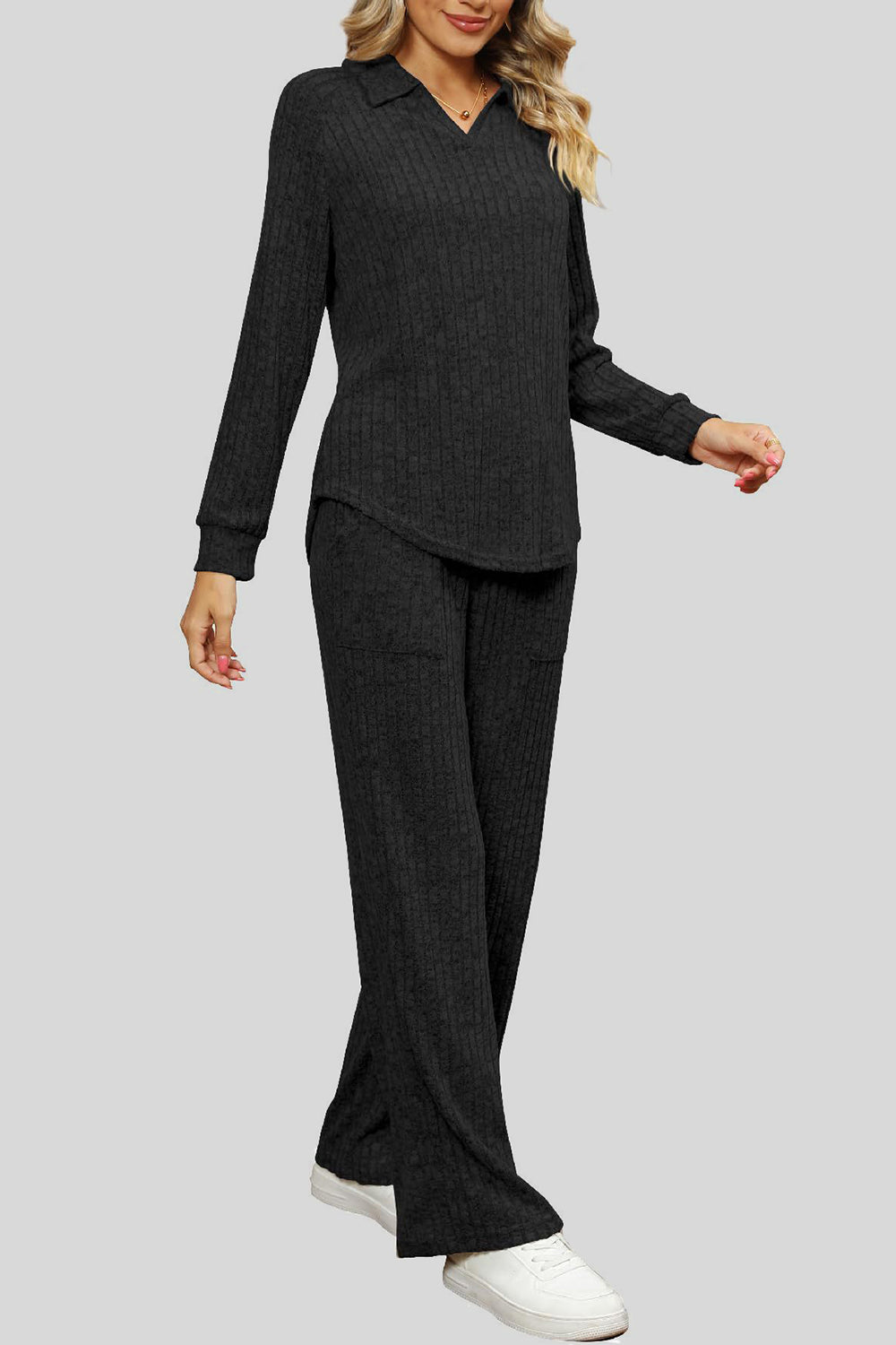 Black ribbed knit lounge set with collar and long sleeves, wide leg pants with pockets.