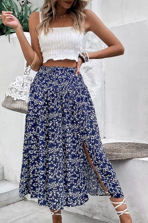 Ditsy floral midi skirt in blue with a high slit and smocked waist.
