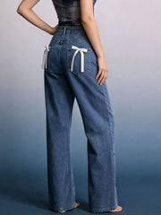 Maternity wide-leg jeans in blue denim with white bow back pockets.