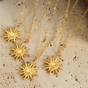 Golden sunburst pendant necklace with adjustable chain, 18K gold-plated.