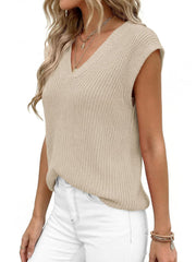 Textured apricot V-neck sweater vest with a ribbed knit and sleeveless design.