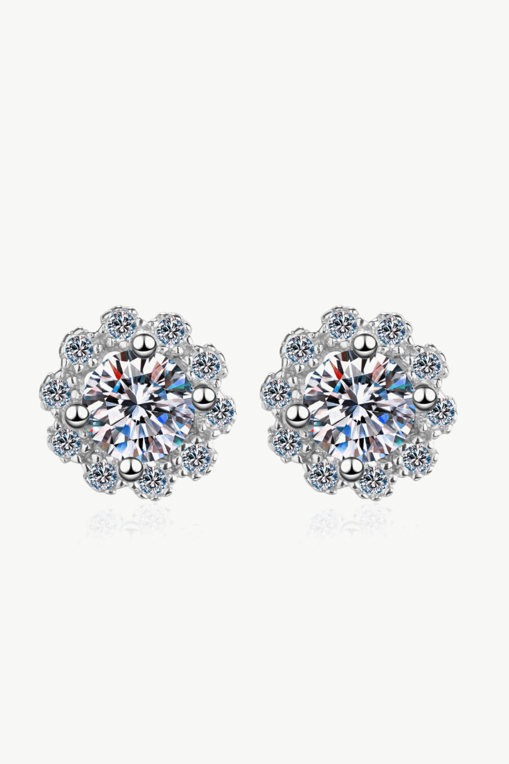 Floral halo stud earrings in 925 sterling silver with clear cubic zirconia stones.