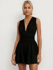 Black textured ribbed plunge romper with ruched waist and flared skirt