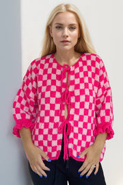 Checkered tie-front knit cardigan with ruffle sleeves in hot pink and blush pink.