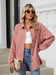 Dusty Pink oversized corduroy shirt jacket with button front and collar, styled open over white crop top.