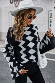 Black chevron knit sweater with bell sleeves and a crew neck.