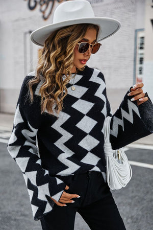 Black chevron knit sweater with bell sleeves and a crew neck.