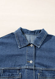 Oversized denim trucker jacket in medium blue wash with button closure and chest pockets.