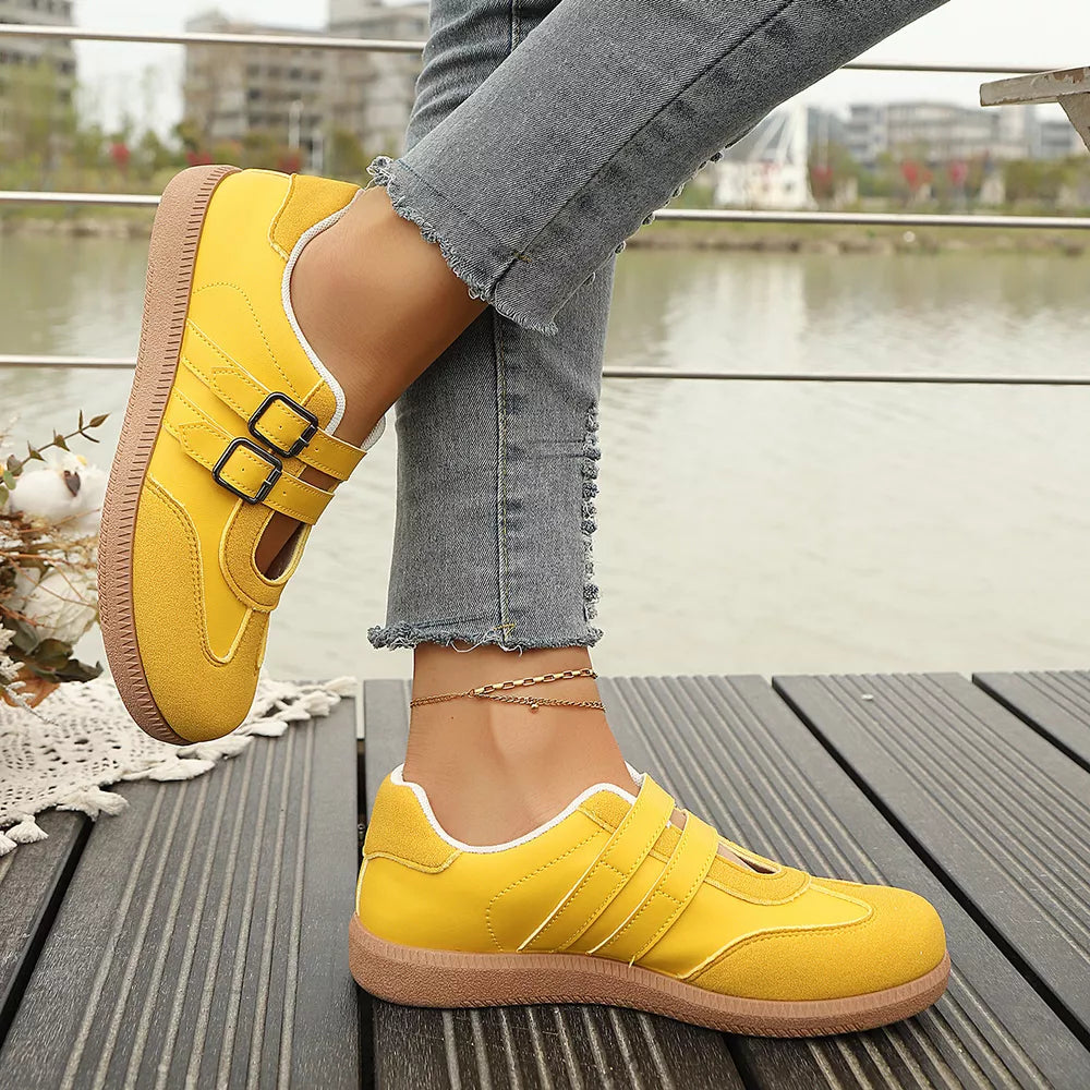 Yellow buckle strap Mary Jane inspired sneakers with double buckle detail and contrast stitching.