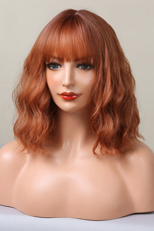 Rose Quartz bob wig in ochre with bangs and wavy texture.
