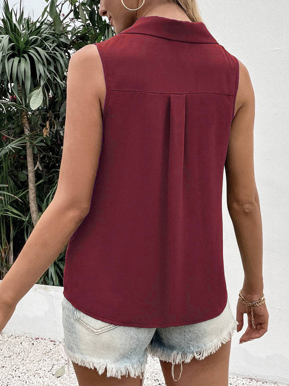 Burgundy sleeveless collared button-down blouse with back pleat detail