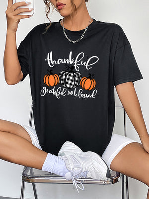 Black oversized graphic tee with thankful pumpkins and text, crew neck, short sleeves.