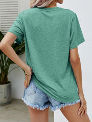 Green graphic tee with short sleeves and a crew neck, paired with distressed denim shorts.