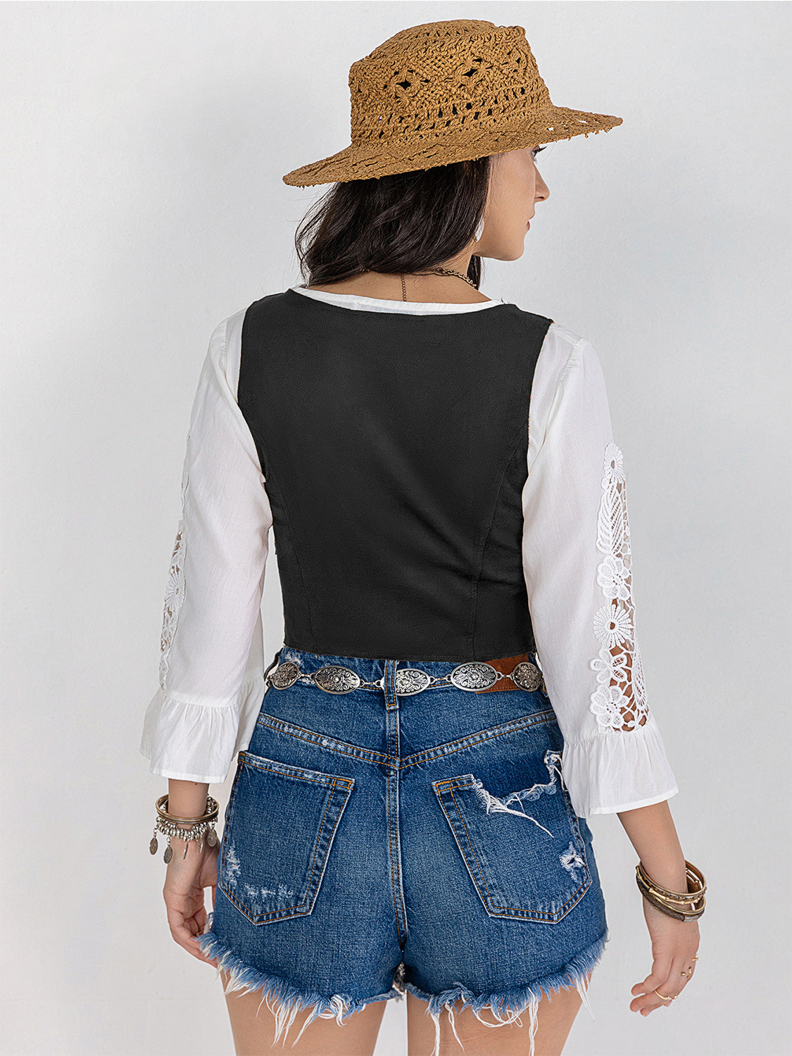 Black lace-up corset vest with white peasant sleeves and lace trim.