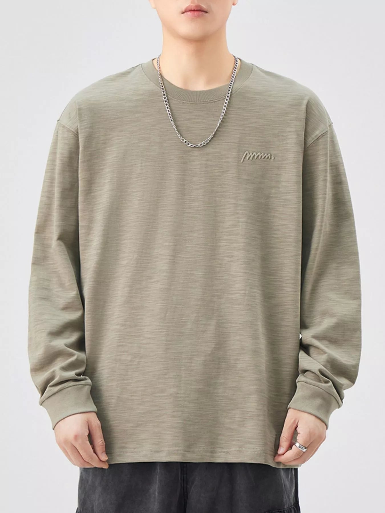 Oversized Khaki Color cotton long-sleeve tee with subtle embroidered logo detail.