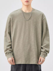 Oversized Khaki Color cotton long-sleeve tee with subtle embroidered logo detail.