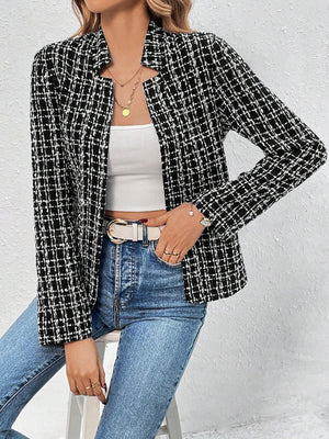 Black and white tweed open-front blazer with a plaid pattern, worn with a white top and jeans.