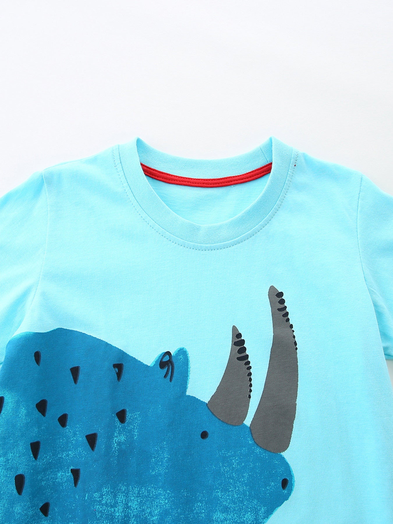 Blue cotton baby t-shirt with rhino graphic and red neck trim