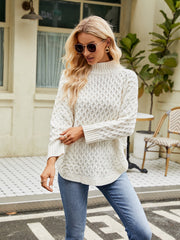White acrylic turtleneck sweater with diamond knit texture and cuffed sleeves.