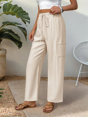 Chic tan waist-tie flare trousers with cargo pocket detail.