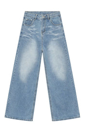Oversized medium wash denim jeans with distressed details and wide leg.