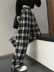 High waist wide leg pants in black and white plaid with drawstring detail.
