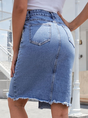 Slit-front frayed denim pencil skirt in medium blue with back pockets and raw hem.
