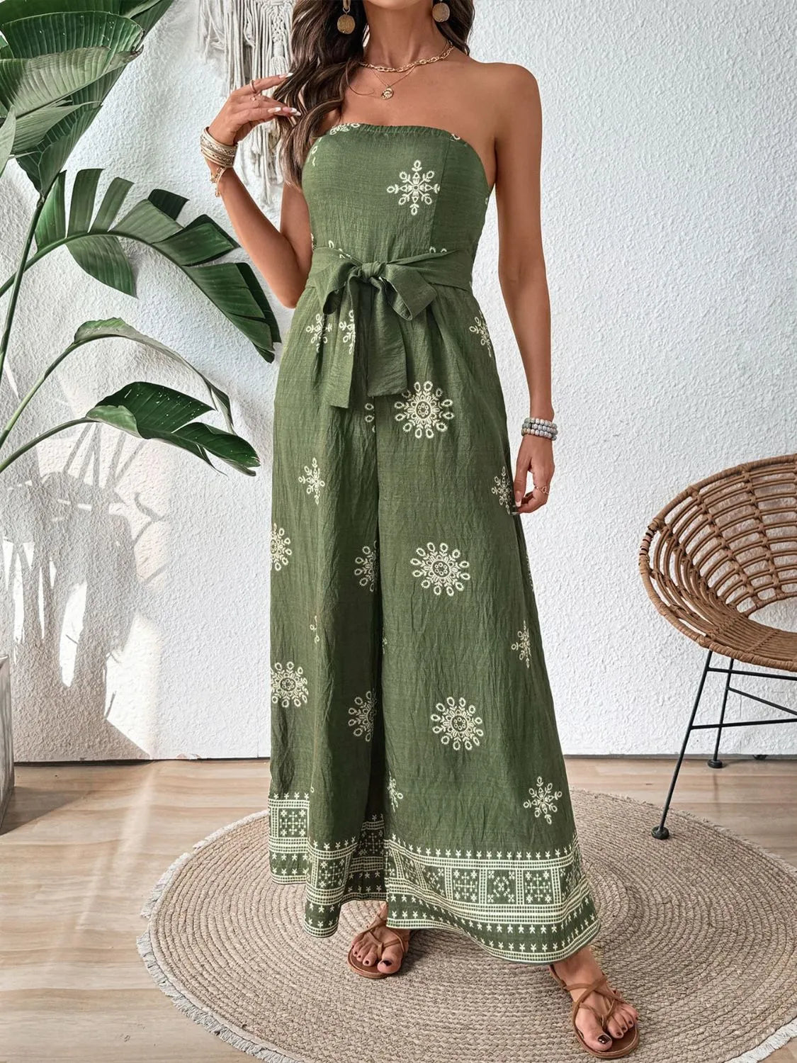 Matcha green bandeau jumpsuit with white embroidery and wide legs, tied waist.