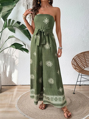 Matcha green bandeau jumpsuit with white embroidery and wide legs, tied waist.