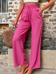 Drawstring linen palazzo trousers in cerise with a relaxed fit and button detail pockets.