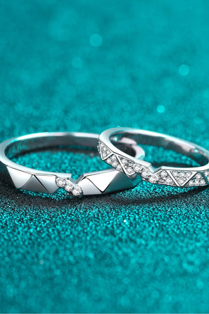 Geometric rhodium pavé ring set with cubic zirconia accents on a teal sparkly background
