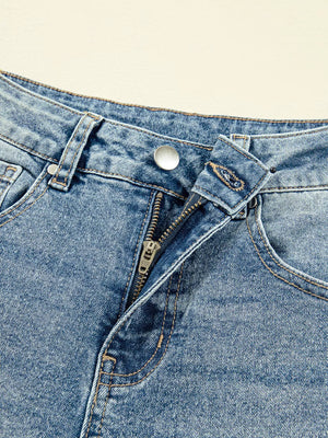 Vintage-inspired high-waisted seam jeans in blue denim with a zip fly and button closure.
