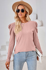 Blush pink textured crew neck top with puff sleeves and diamond pattern.