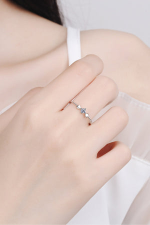 Sterling silver ring with heart motif and moissanite center stone.