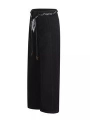 Black maternity pants with wide legs and a patterned belt with beaded ties.