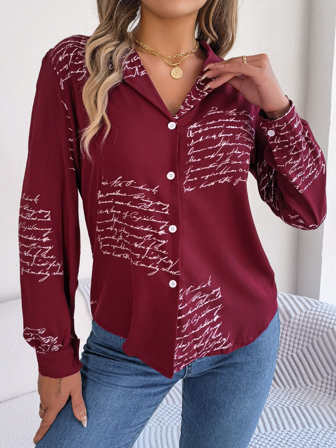 Burgundy collared blouse with white script print, button front, and collared neckline.