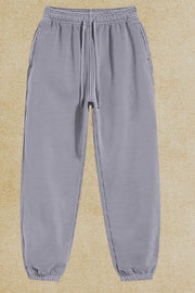 Gray relaxed fit drawstring sweatpants with cuffed ankles and side pockets.