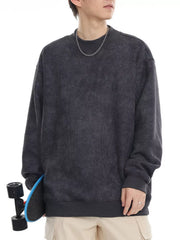 Dark gray oversized corduroy sweatshirt with round neck and ribbed cuffs and hem.