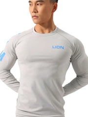 Gray performance raglan sleeve tee with blue logo on chest and sleeve.