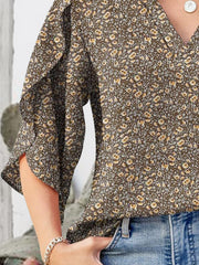 Floral v-neck blouse with flutter sleeves and a brown floral print.