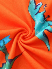 Orange toddler tee with blue skateboarding dinosaur print, lightweight fabric.