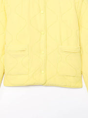 Yellow quilted snap puffer jacket with wave stitching and patch pockets.