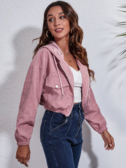 Cropped corduroy hooded jacket in blush pink with zip front and chest pockets.
