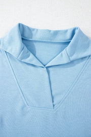 Light blue activewear shorts with a V-neck collar detail