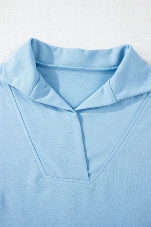 Light blue activewear shorts with a V-neck collar detail