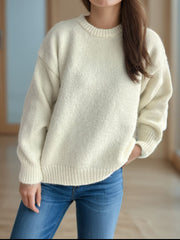 Oversized cream crewneck sweater with textured knit and ribbed cuffs and hem.