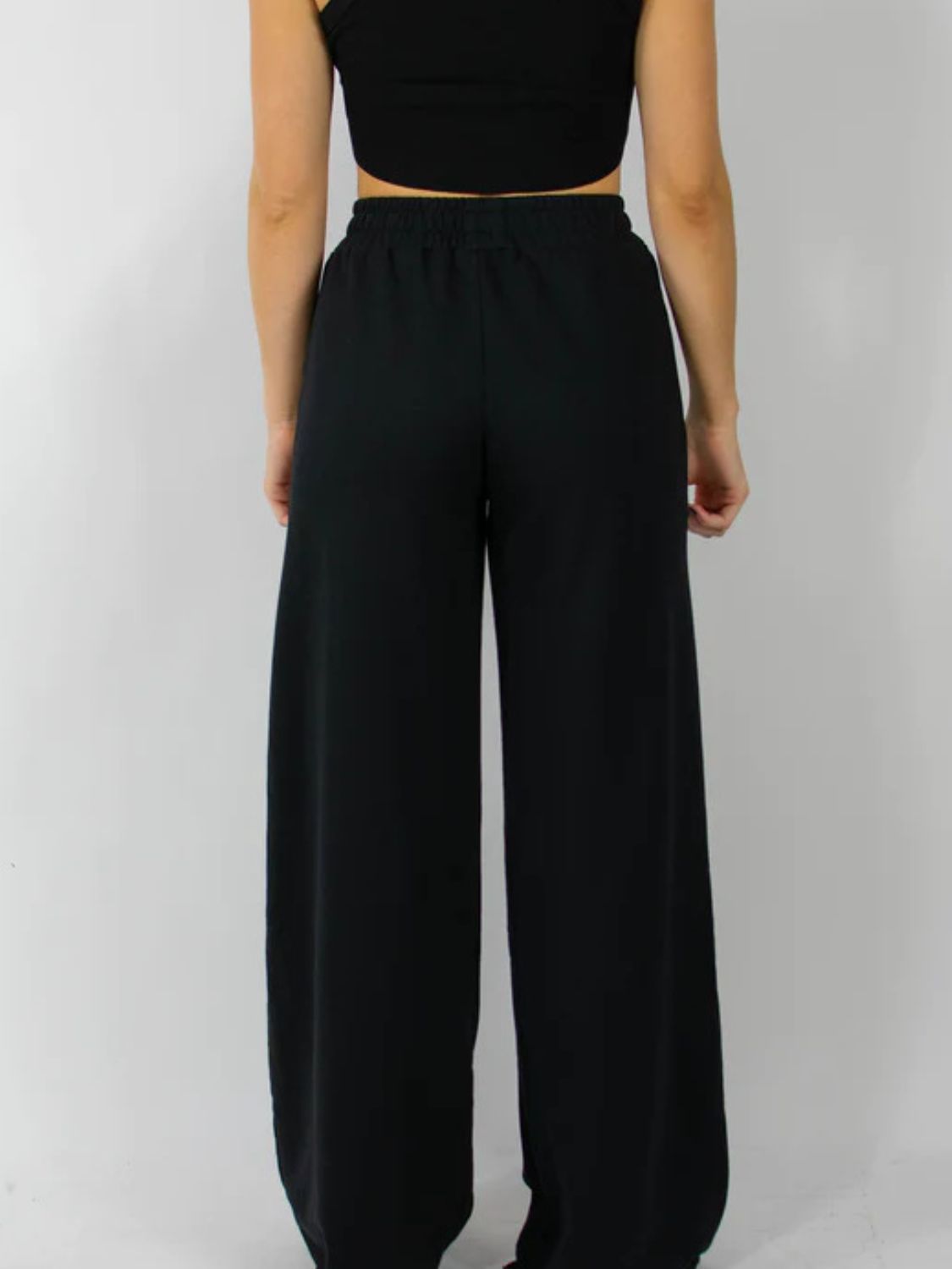 Black wide-leg lounge pants with an elastic waistband.
