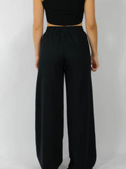 Black wide-leg lounge pants with an elastic waistband.