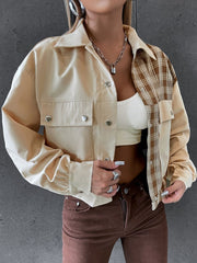 Beige panelled jacket with faux leather and plaid sleeves, buttoned front and pockets.