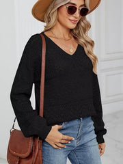 Black eyelet stitch V-neck pullover sweater with long sleeves and textured knit details.
